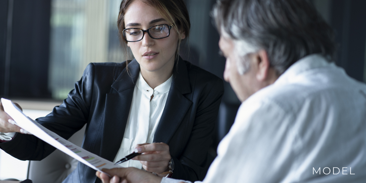 A woman and man looking over tax documents
